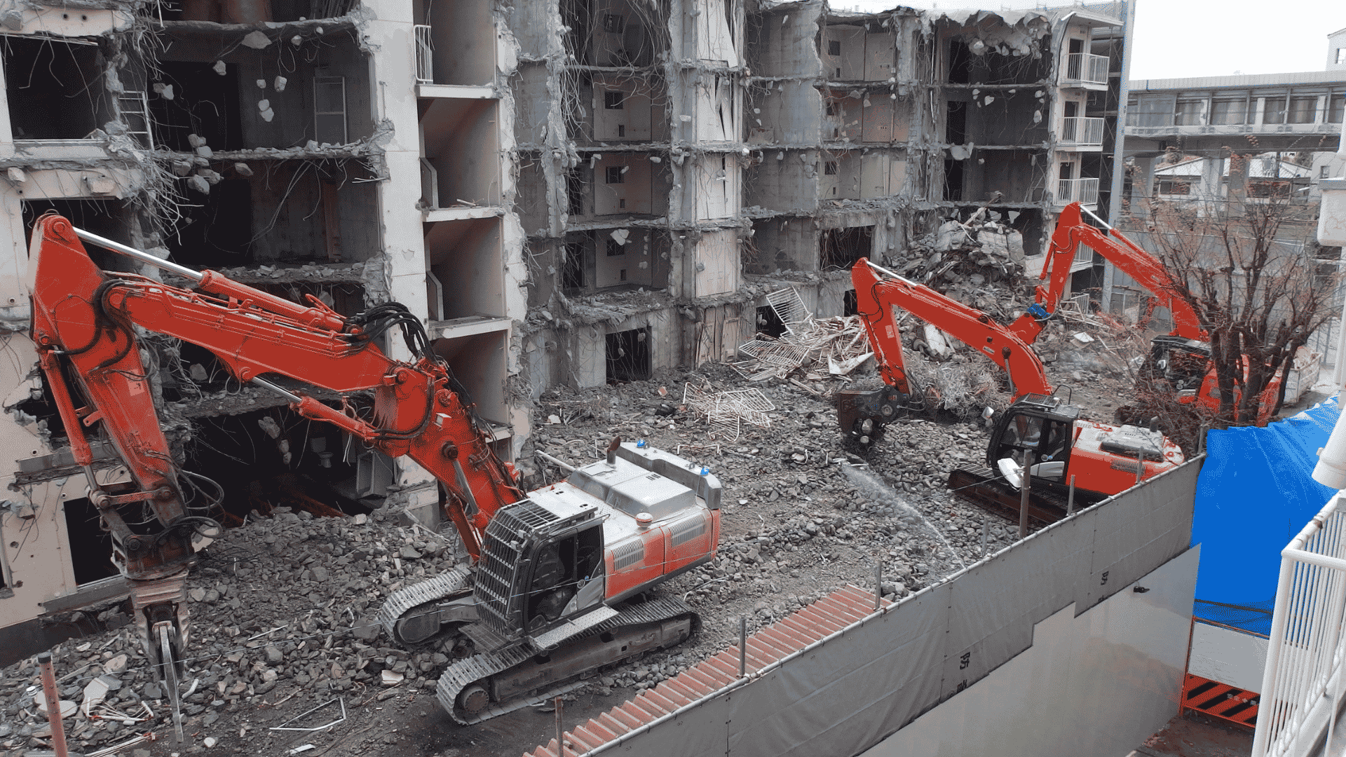 excavators performing commercial building demolition and debris removal